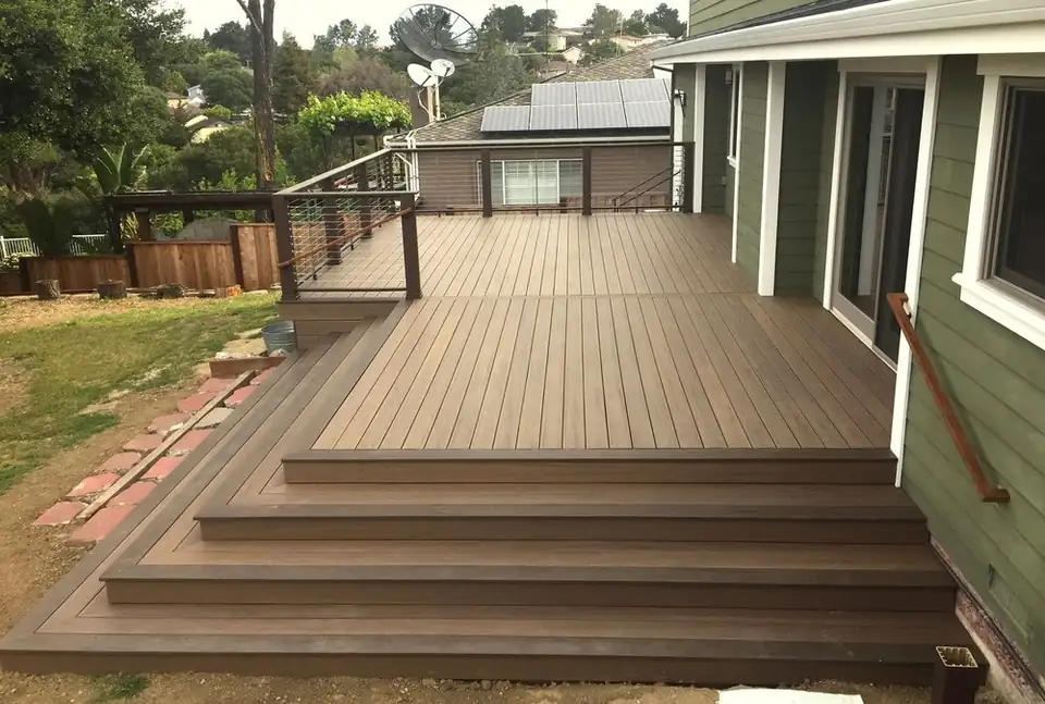 Backyard deck with broad steps leading to the lawn