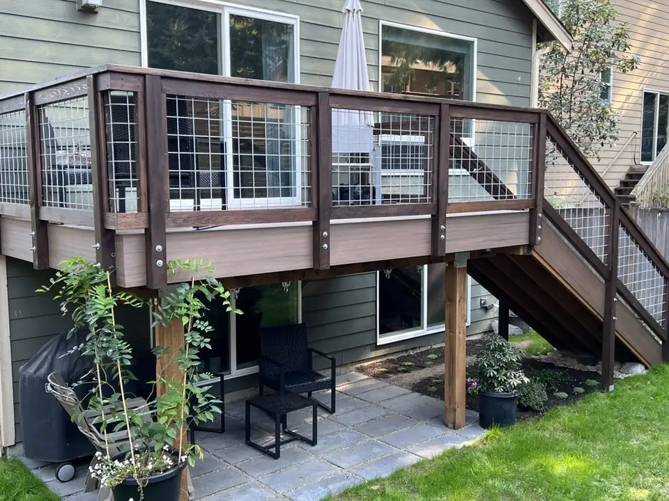 Raised deck with wire-panel railing and stairs down to the yard